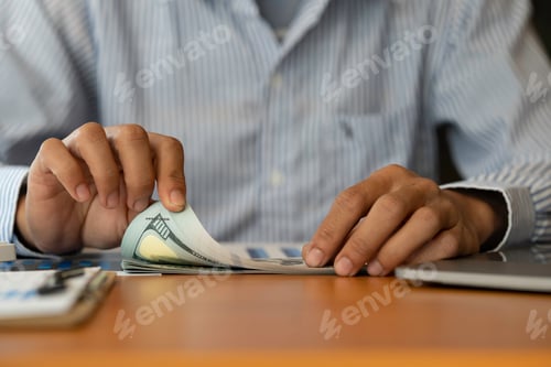Preview: Person Counting Money at Desk