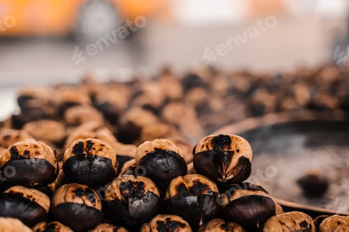 Preview: Grilled roasted chestnuts on pan, street market snack food