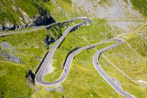 Preview: Aerial view of the winding Transfagarasan Highway in Romania surrounded by a mountainous landscape