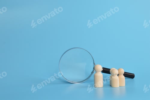 Preview: Wooden doll figures and magnifying glass. The concept of search for vacancies and work