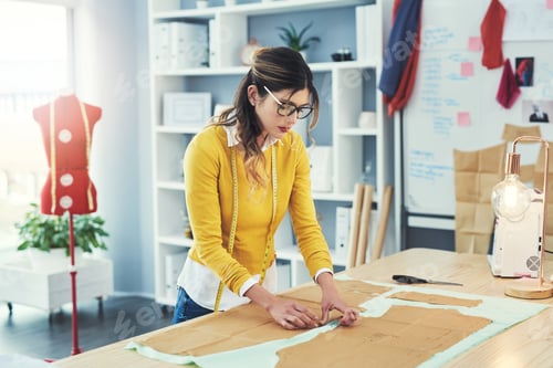 Preview: Cropped shot of an attractive young fashion designer in her workshop