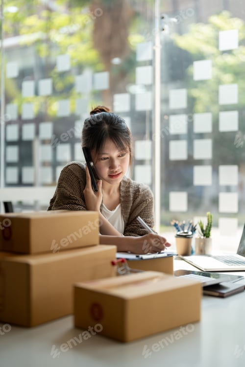 Preview: Young woman small business owner online shopping at home. confirm orders from customers with mobile