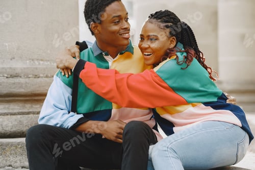 Preview: Ethnic couple sitting in city street