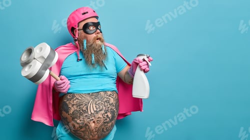 Preview: Stupefied male hero in special costume ready to clean everything in your house and remove dirt holds