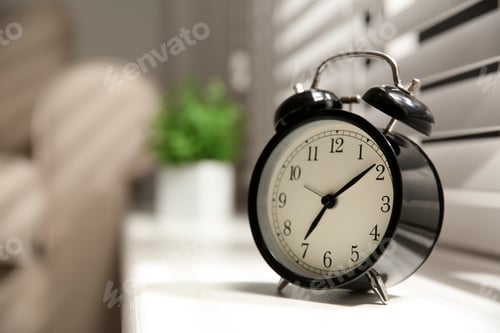 Preview: Alarm clock on windowsill, space for text. Morning time