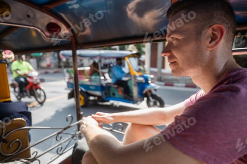 Preview: Man enjoying tuk tuk ride in Bangkok