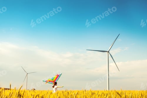 Preview: Happy Little girl running in a wheat field with a kite in the summer.