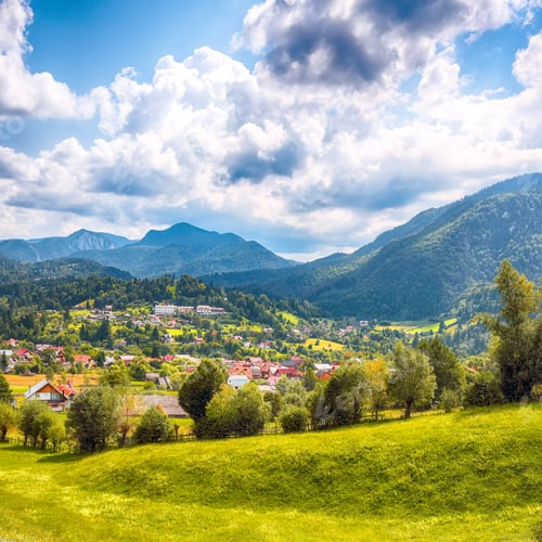 Preview: Stunning alpine landscape with green fields and Piatra Craiului mountains in Dambovicioara Commune