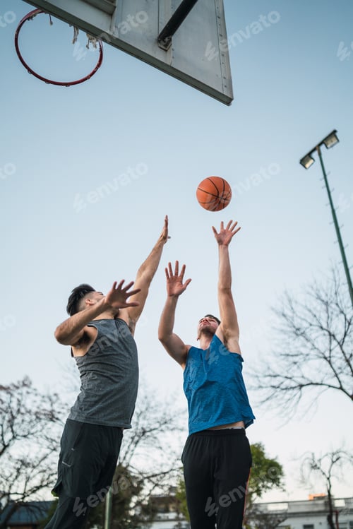 Preview: Two young friends playing basketball.