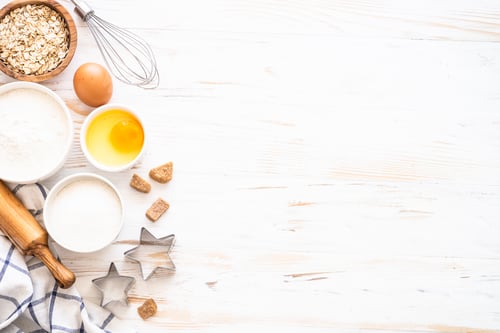 Preview: Baking ingredients at white wooden table.