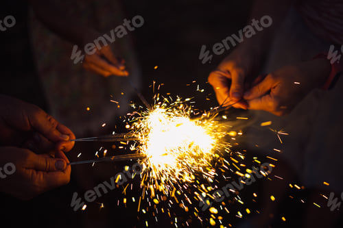Preview: Anonymous person with burning firework