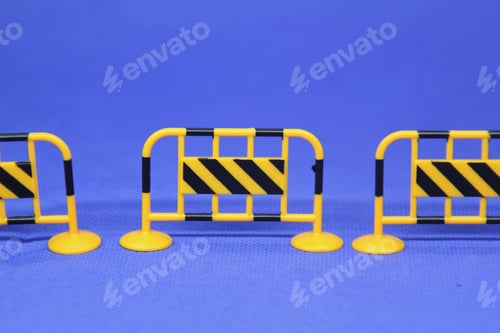 Preview: construction cover fence is blackish yellow with a blurred background. Selective focus