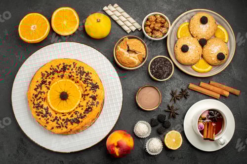 Preview: top view yummy fruity cake with cookies and cup of tea on dark background biscuit cookie tea sweet
