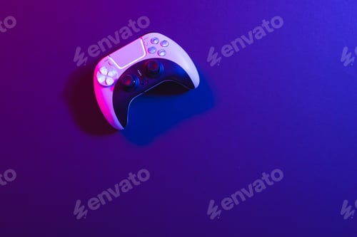 Preview: Composite of video game pad and copy space on neon background