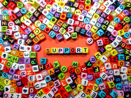 Preview: Selective focus.Colorful dice with word SUPPORT on red background