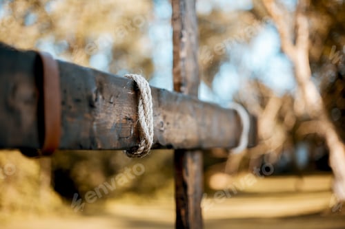 Preview: Selective shot of a wooden hand made a cross with rope wrapped around and a blurred background