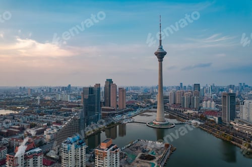 Preview: Aerial shot of Tianjin TV Tower and Water Park Complex near water in China at sunset