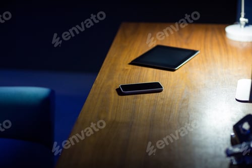 Preview: Digital Tablet And Mobile Phone On Office Desk At Night