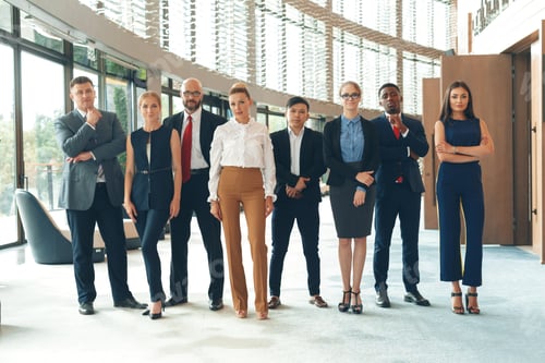 Preview: Business team poses confidently in modern office setting during daytime