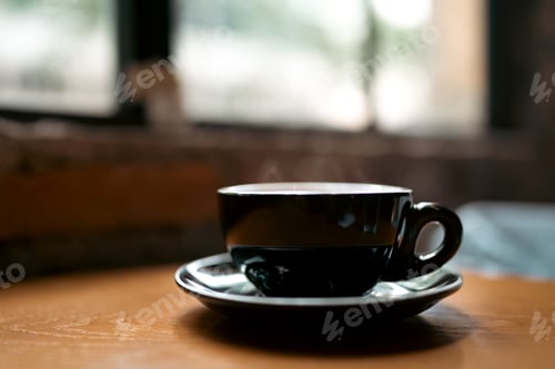 Preview: A cup of coffee near window with shadow