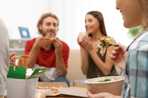 Preview: Young people having lunch together at home. Food delivery