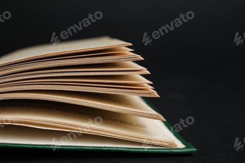 Preview: Closeup view of open book on black background