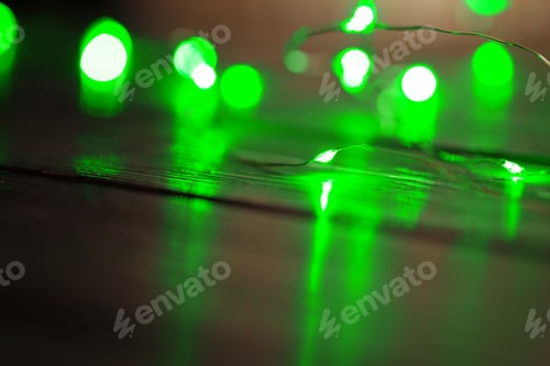 Preview: Garland with green light elements in the dark close up