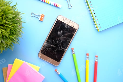 Preview: Top view of broken smart phone and stationary on color background
