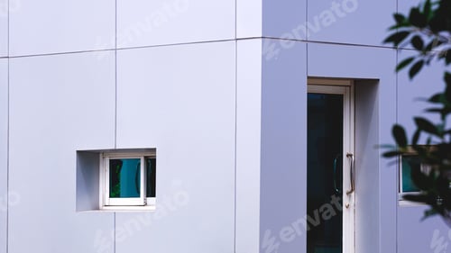 Preview: Gray aluminium composite tile wall of modern security guardhouse in front of gated community