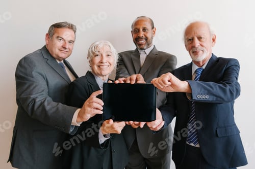 Preview: Senior business team showing a tablet screen