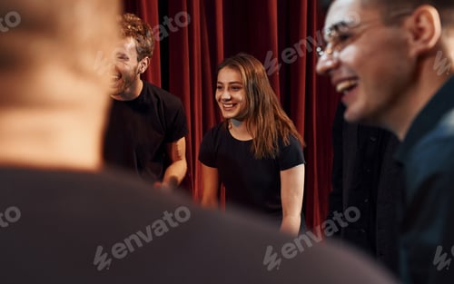 Preview: Group of actors in dark colored clothes on rehearsal in the theater