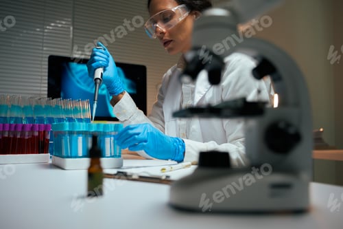 Preview: Scientist conducting research developing new medicine in laboratory
