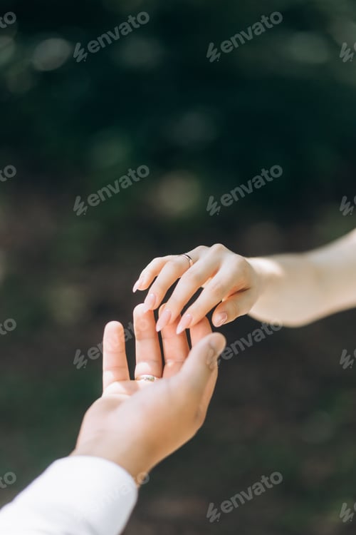 Preview: A happy young couple in walk in a garden. A man in a white shirt and a girl in a white light dress