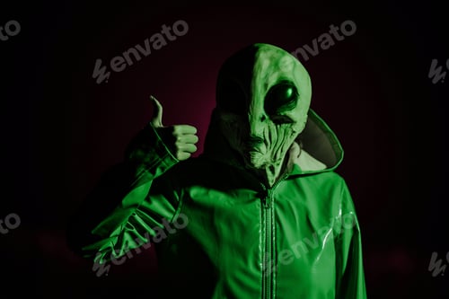 Preview: Alien showing thumb up. Like gesture. Creepy mask of humanoid on neon planet in smooth raincoat.