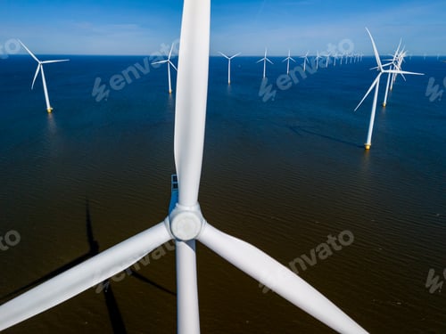 Preview: A cluster of towering wind turbines stands tall in the ocean in the spring breeze