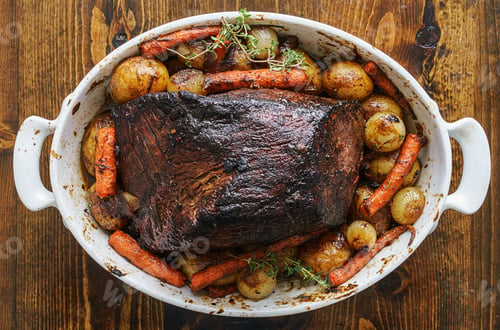 Preview: beef roast with carrots and potatoes in baking dish in flat lay composition