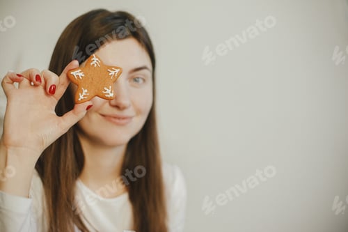 Preview: Beautiful woman holding christmas gingerbread cookie star on white background. Merry Christmas !