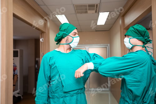 Preview: Caucasian surgeon doctor elbow bump greeting for social distancing