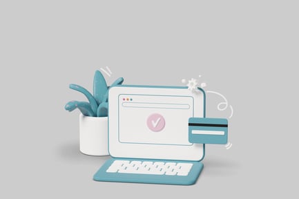 Modernes digitales Büro mit Computer, Tastatur, Kreditkarte und Pflanze.