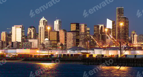 Preview: The Seattle Washington waterfront glows at dusk showing tanks on the port