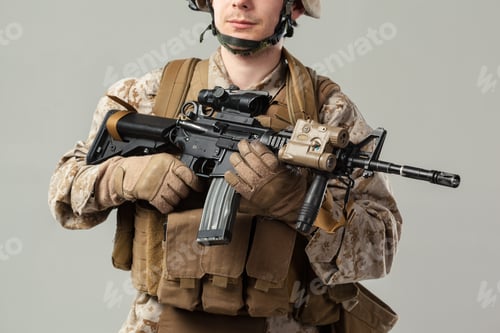 Preview: Soldier holds firearm while wearing tactical gear in indoor setting