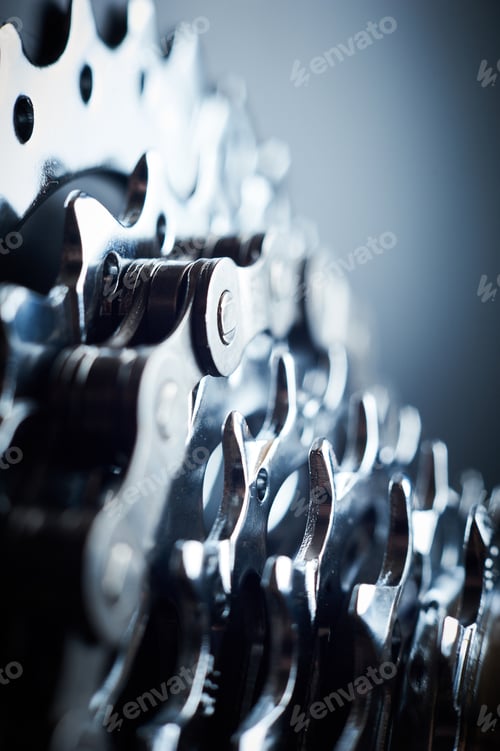 Preview: New rear mountain bike cassette with chain on the black background close up