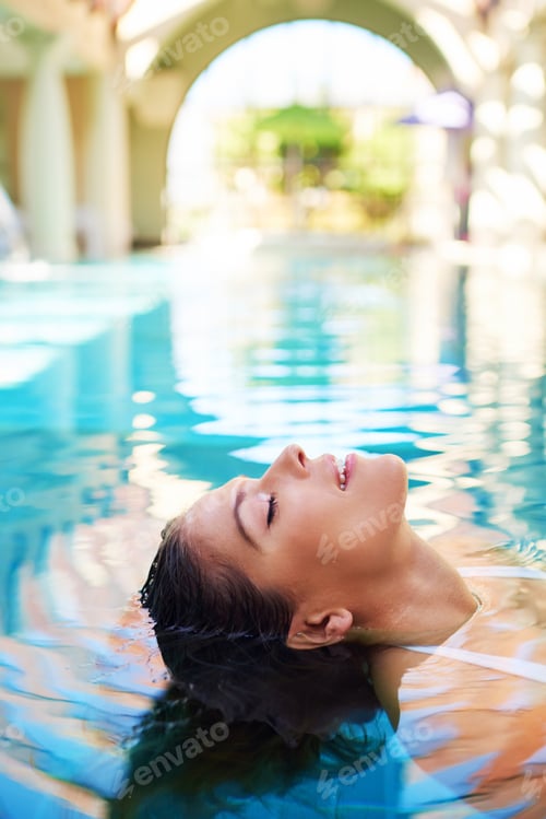 Relaxing Woman Floating in a Pool
