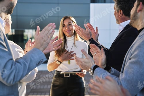 Preview: entrepreneurs applauding businesswoman after presentation. Focus on hands applauding