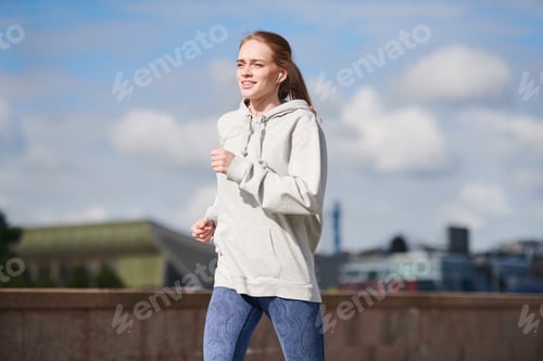 Preview: Sporty teenage girl jogging alone