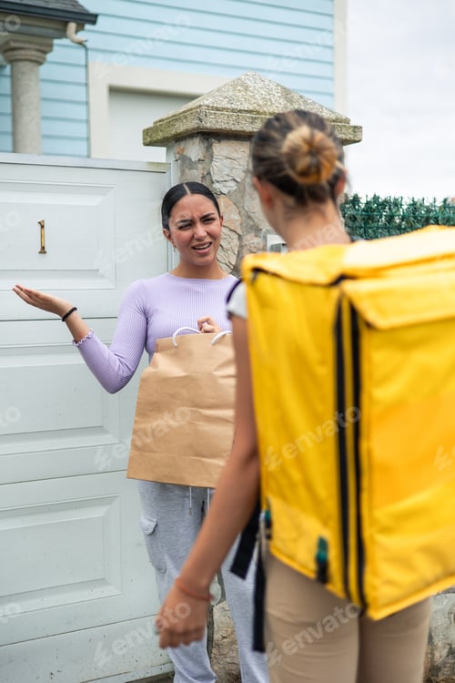 Preview: vertical Latina customer expressing frustration to food delivery girl over delayed order