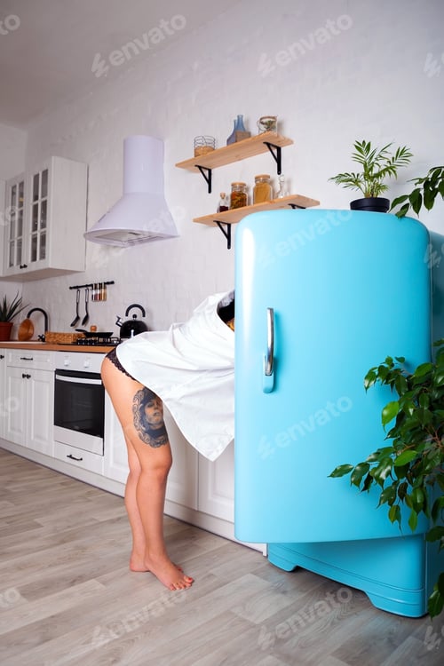 Preview: Women looking in refrigerator for some sweet food