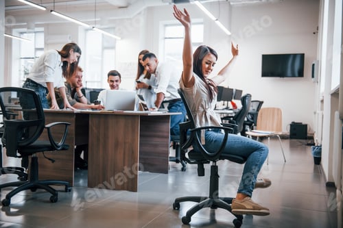 Preview: Young business people working together in the modern office