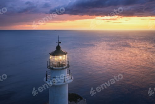 Preview: Lighthouse at colorful sunset in summer. Aerial view from drone