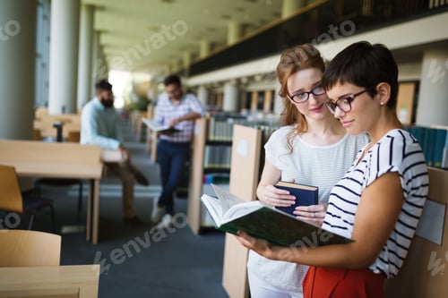 Preview: Group of happy young college students studying
